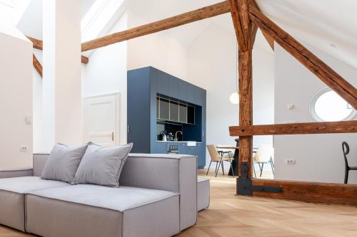 a living room with a white couch and a blue cabinet at Villa Elizabeth - Mansard Apartment for 4 in Slovenj Gradec