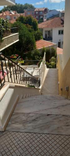 a set of stairs leading up to a building at Apartamento do jardim in Cascais