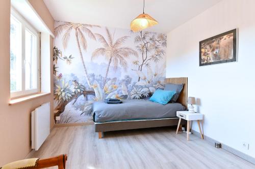 a bedroom with a bed with a mural of palm trees at Gîte les Rosiers du Blosen in Thann