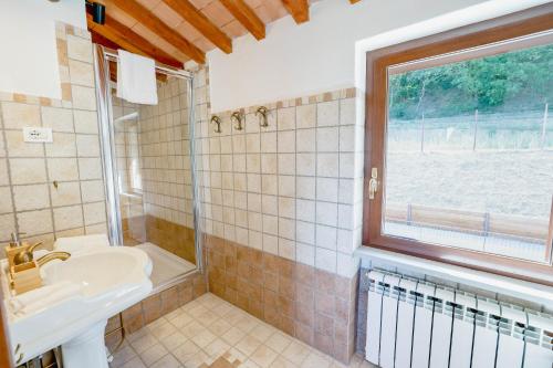 a bathroom with a sink and a window at Villa Destino Italy, Umbria Tuscany boarder in Montone