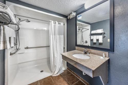a bathroom with a sink and a shower at Quality Inn Glasgow in Glasgow