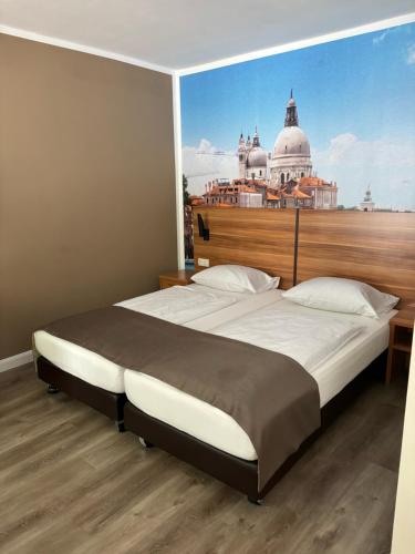 a bedroom with a large bed with a view at Hotel Schlangenbader Hof in Schlangenbad