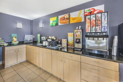 a restaurant kitchen with a counter top with aperature at Quality Inn Glasgow in Glasgow