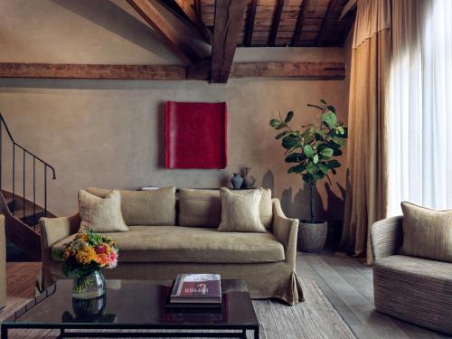 a living room with a couch and a table at Botanic Sanctuary Antwerp - The Leading Hotels of the World in Antwerp