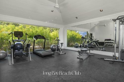 a gym with several exercise equipment and a large window at Long Bay Beach Club in Long Bay Hills