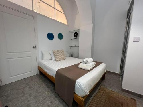 a small bedroom with a bed and a door at Budget-friendly 1BR in the city center in Gibraltar