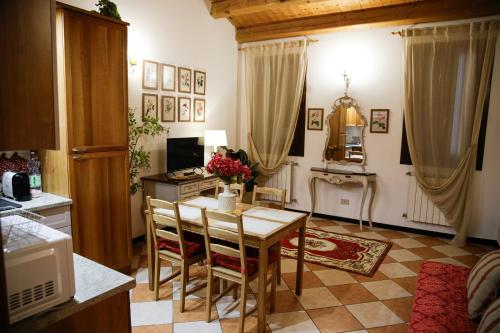 a kitchen with a table and chairs in a room at Floreal House - Classic style apartment in Rovigo