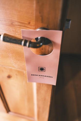 a wooden door with a tag on a wooden drawer at Solar Madariaga Hotel in Vicuña