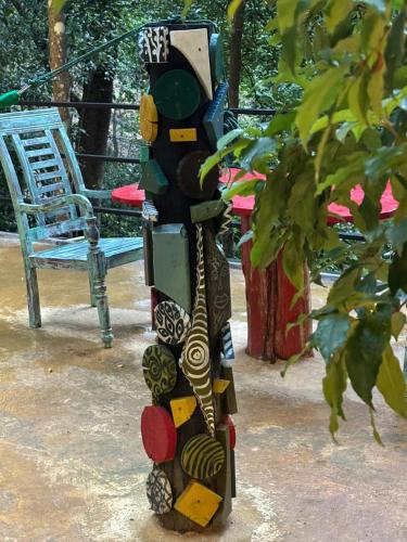 a sculpture of a person standing next to a chair at Enchanted Villa in Kandy