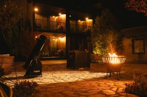a fire pit in a courtyard at night at Solar Madariaga Hotel in Vicuña