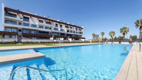 a large swimming pool in front of a building at Oceans Oliva in Oliva