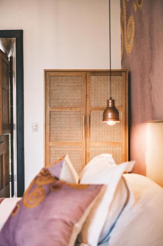 a bedroom with a book on a bed with a lamp at Solar Madariaga Hotel in Vicuña