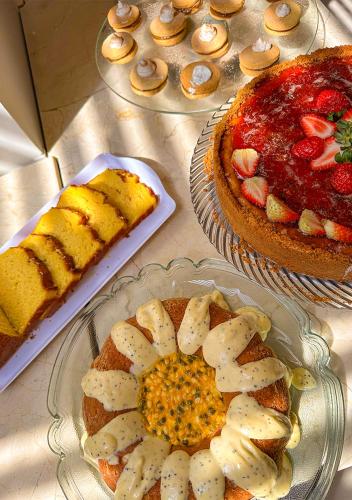 a table topped with two plates of food and a cake at Grande Hotel Petrópolis in Petrópolis
