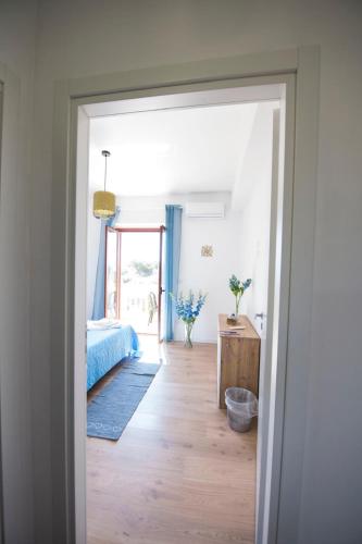 a bedroom with a bed and a wooden floor at B&B Casa Cosmano in Brancaleone Marina