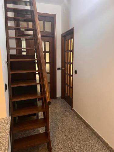 a staircase leading to a room with two doors at Sea Gargano Home in Poggio Imperiale