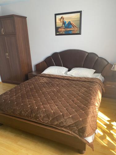 a bedroom with a bed with a brown bedspread at Apartments in Umanʼ