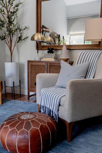 a living room with a couch and a mirror at Peaceful, modern, renovated, close to everything! in Gainesville