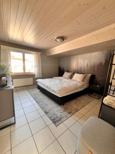 a bedroom with a bed and a wooden ceiling at Ferienwohnung SUN SAND SEA in Horn