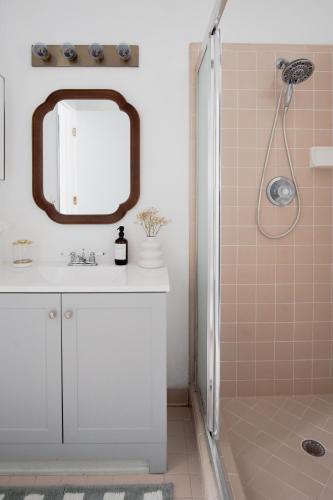 a bathroom with a white sink and a mirror at Peaceful, modern, renovated, close to everything! in Gainesville