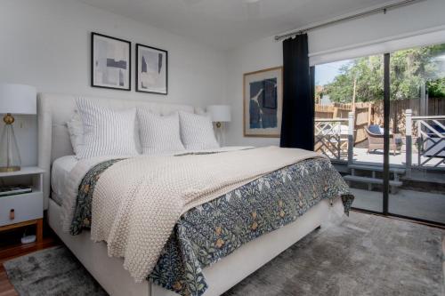a bedroom with a bed and a large window at Peaceful, modern, renovated, close to everything! in Gainesville
