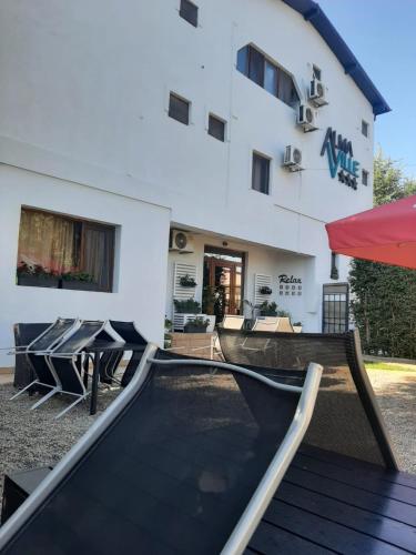 a house with a ramp in front of a building at AlmaVille Mamaia in Mamaia Sat/Năvodari
