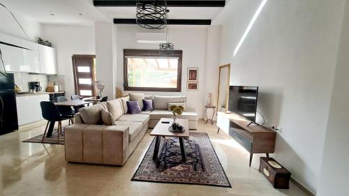 a living room with a couch and a table at La Maisonette, Florina Center in Florina