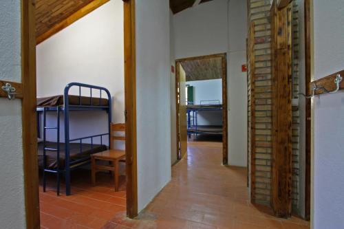 a hallway with a room with a bedroom and a bunk bed at El Xalió in Sant Miquel de Campmajor