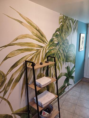 a plant mural on the wall of a room with stairs at Le Logis d'Elisa in Cosne Cours sur Loire