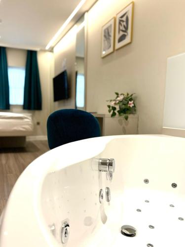 a bathroom with a white sink and a blue chair at NOX Richmond in Richmond
