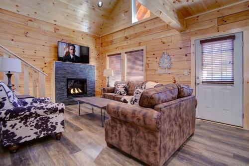 a living room with a couch and a fireplace at NEW BUILD-5BD-Hottub-WIFI-Theater-Pool Tble-ROKU in Pigeon Forge