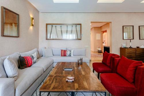 a living room with a couch and a coffee table at Villa Atlas Harmony Marrakech in Marrakech