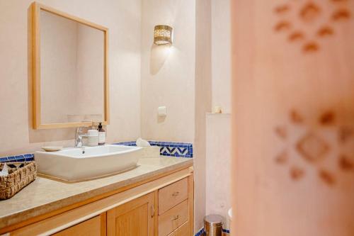 a bathroom with a white sink and a mirror at Villa Atlas Harmony Marrakech in Marrakech