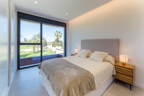 a bedroom with a large bed and a large window at Oceans Oliva in Oliva