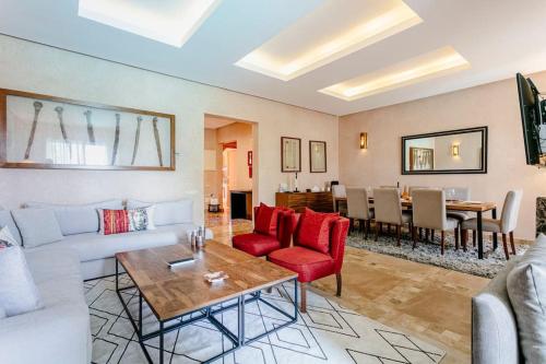 a living room with a couch and a table at Villa Atlas Harmony Marrakech in Marrakech