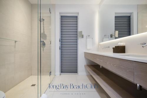 a bathroom with a glass shower and a sink at Long Bay Beach Club in Long Bay Hills