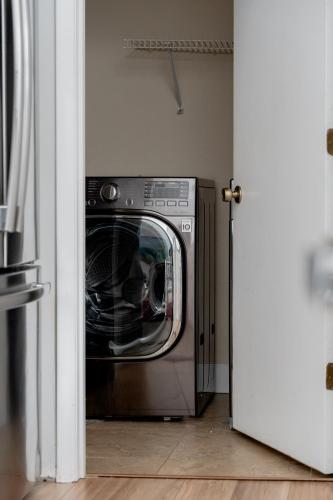 a silver washer and dryer in a room at Quiet, convenient & Modern Haven in Gainesville