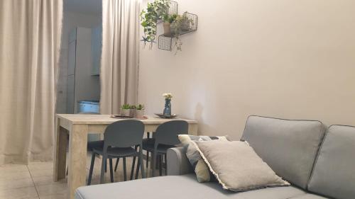 a living room with a couch and a table with chairs at Evesea in Francavilla al Mare
