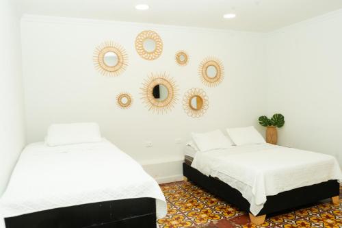 two beds in a room with mirrors on the wall at Puesta del Sol Guest House in San Andrés