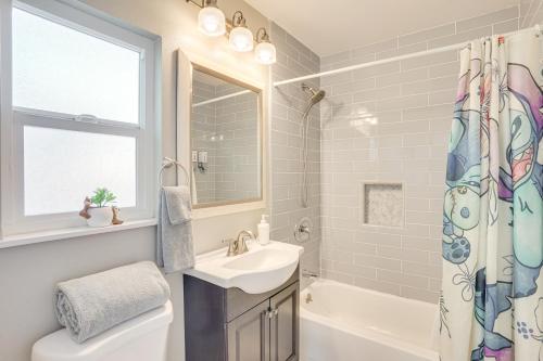 a bathroom with a sink and a tub and a toilet at Fullerton Vacation Rental with Private Pool! in Fullerton