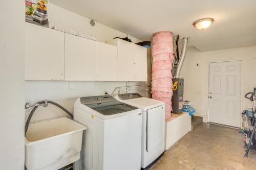 a kitchen with a washing machine and a sink at Fullerton Vacation Rental with Private Pool! in Fullerton