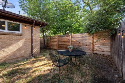 a patio with a table and chairs and a fence at 7290 W 10th Ave in Lakewood