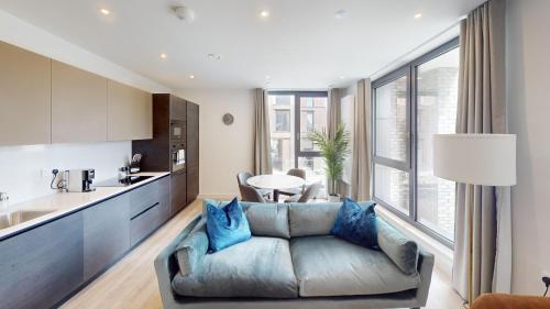 a living room with a couch and a kitchen at Charles Hope Brighton & Hove in Brighton & Hove