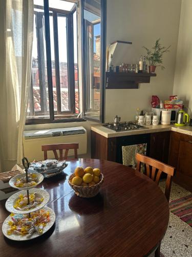 a kitchen with a table with plates of food on it at Rosa apartment in Venice