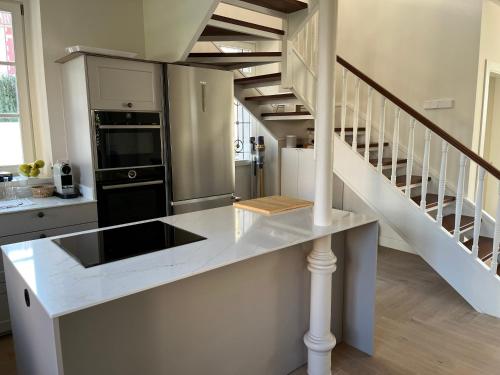 a kitchen with a counter top and a staircase at Espectacular casa en Salinas by BeBalmy in Salinas