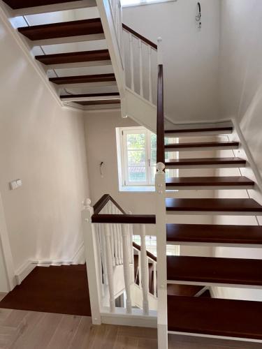 a staircase in a home with white walls and wood floors at Espectacular casa en Salinas by BeBalmy in Salinas