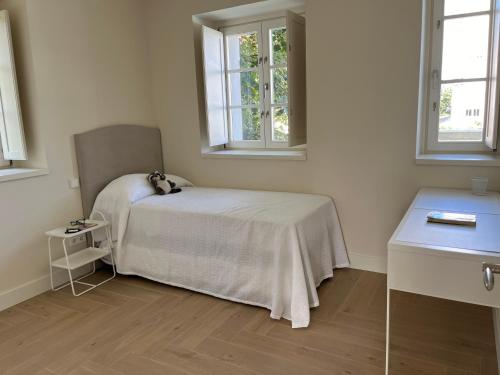 a bedroom with a bed with a teddy bear on it at Espectacular casa en Salinas by BeBalmy in Salinas