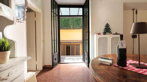 a room with a table and a glass door at Piazza Duomo - 20 min by train to Florence in Prato