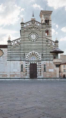 a large building with a clock tower and a door at Piazza Duomo - 20 min by train to Florence in Prato