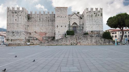 a large castle with two towers on top of it at Piazza Duomo - 20 min by train to Florence in Prato