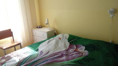 a bedroom with a bed with a blanket on it at Jannseni Accommodation in Pärnu